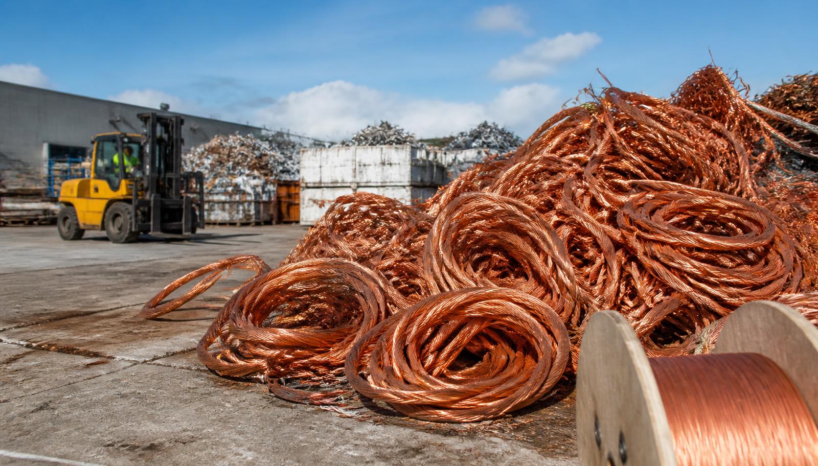 Scrap copper wire coils and cable spools at Allwire Recycling's yard